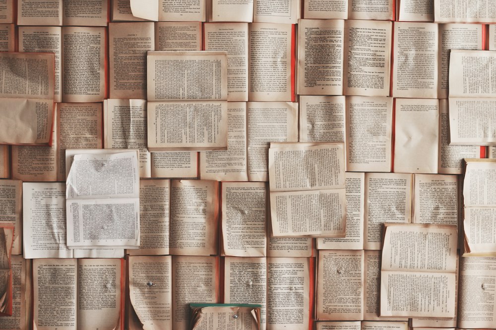 A wall of open book pages arranged in a grid